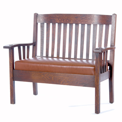 Appraisal: HARDEN Settee with tapering vertical slats under shaped arms and