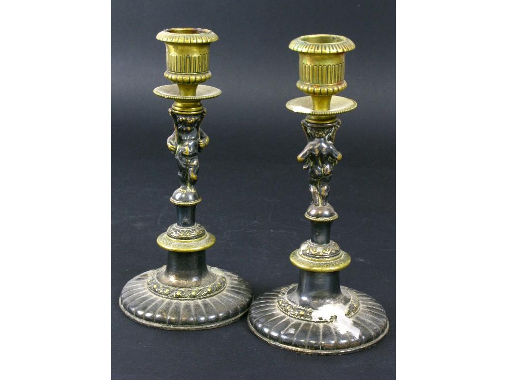 Appraisal: Pair of parcel gilt Candlesticks with cherub figure supports on