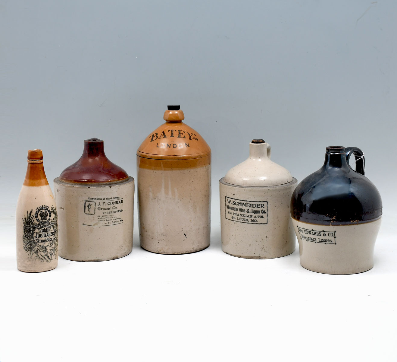 Appraisal: PC ADVERTISING STONEWARE JUGS Comprising - Wm Edwards Co Wholesale