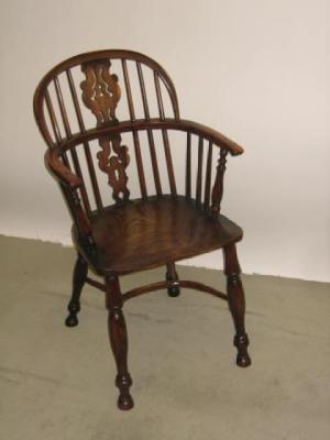 Appraisal: A YEW WINDSOR ARM CHAIR of double hoop back form