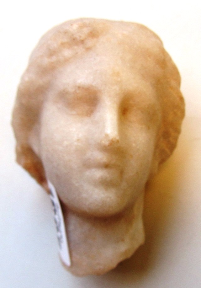 Appraisal: A Roman marble female head her hair dressed in a