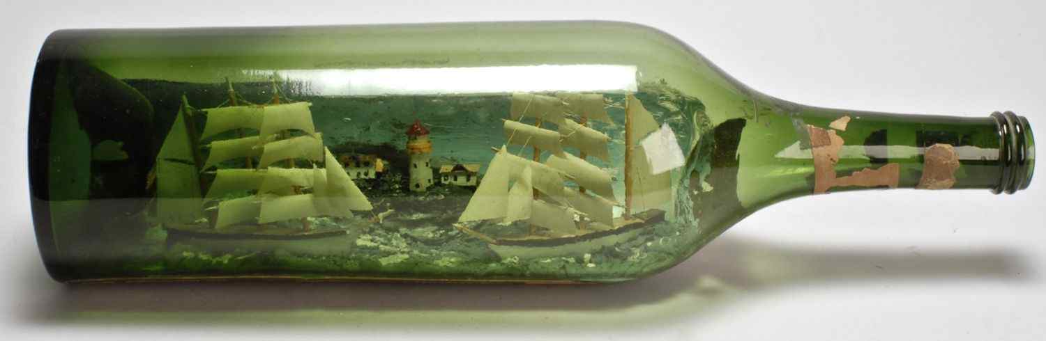 Appraisal: MARITIME DIORAMA IN A LARGE MARTINI ROSSI BOTTLEEarly th CenturyCoastal