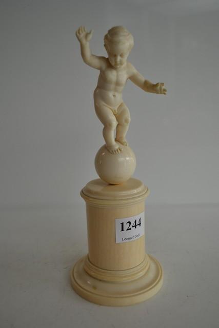 Appraisal: BAVARIAN CARVED CHERUB FIGURE STANDING ON A BALL PLINTH BASE