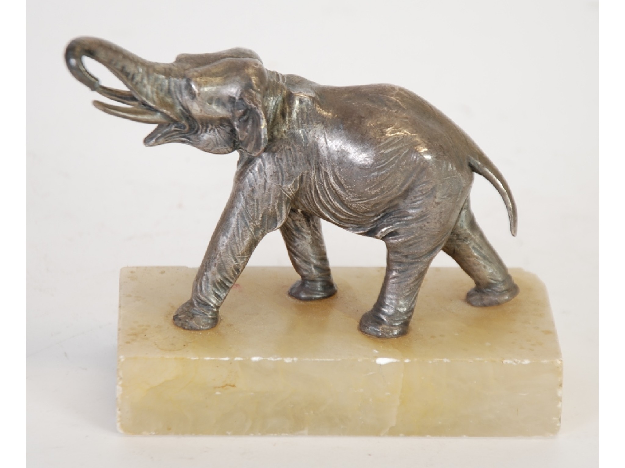 Appraisal: WHITE METAL MODEL OF AN ELEPHANT well moulded with raised