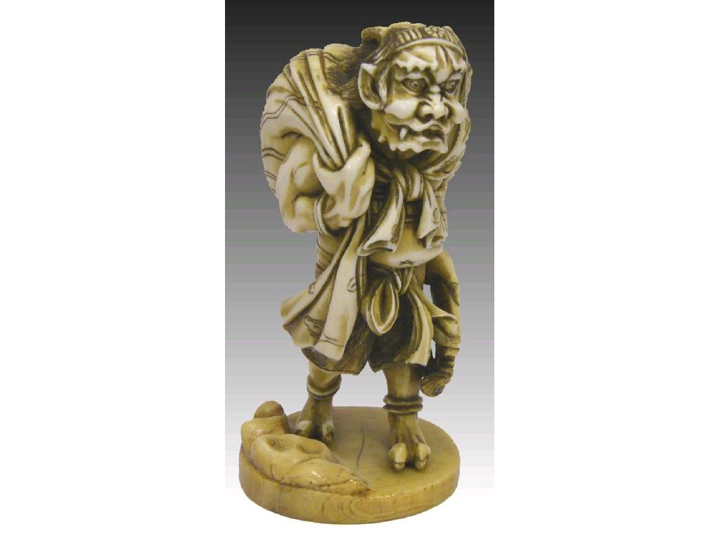 Appraisal: Japanese stained ivory okimono of an Oni modelled holding a