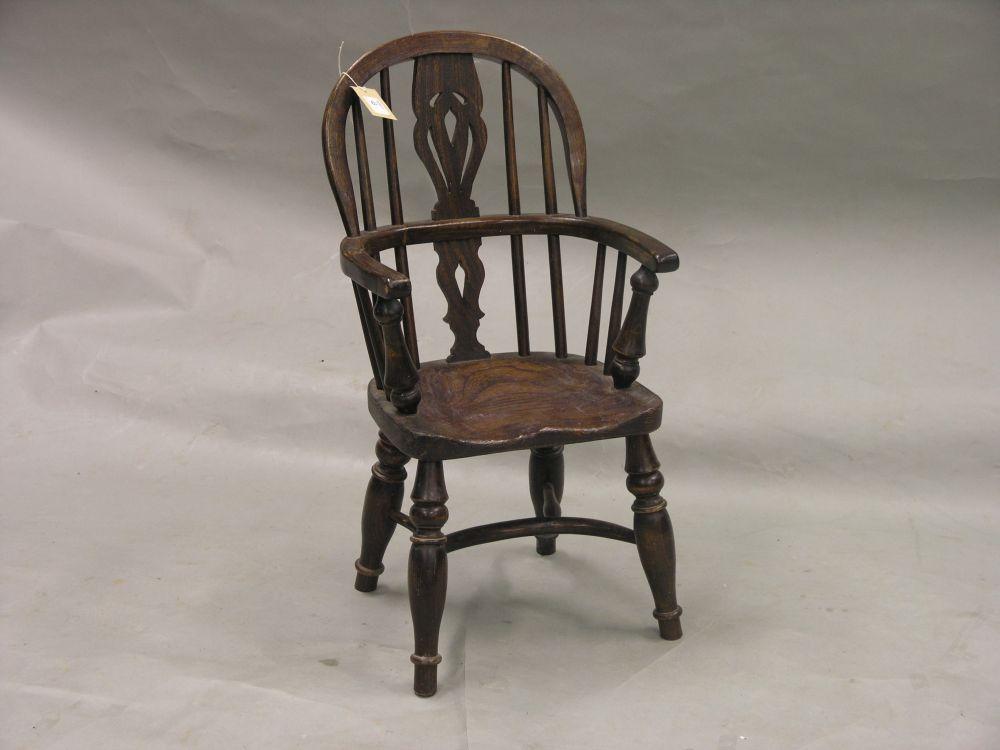 Appraisal: A child's ash and elm Windsor armchair with pierced splat