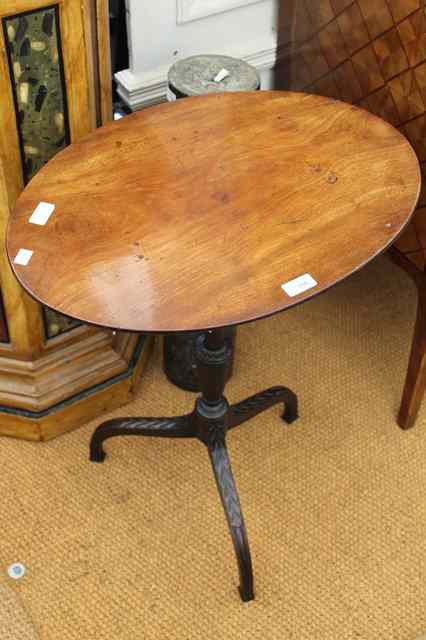 Appraisal: A TH CENTURY MAHOGANY OVAL TOPPED TRIPOD TABLE the turned