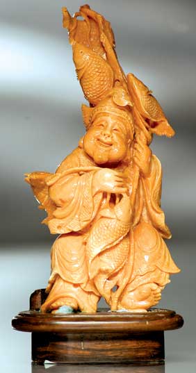 Appraisal: CARVED CORAL DEITY Very elaborately carved coral group of the