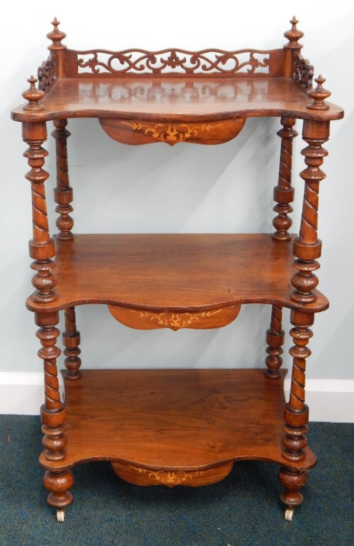 Appraisal: A Victorian figured walnut three tier what not with a