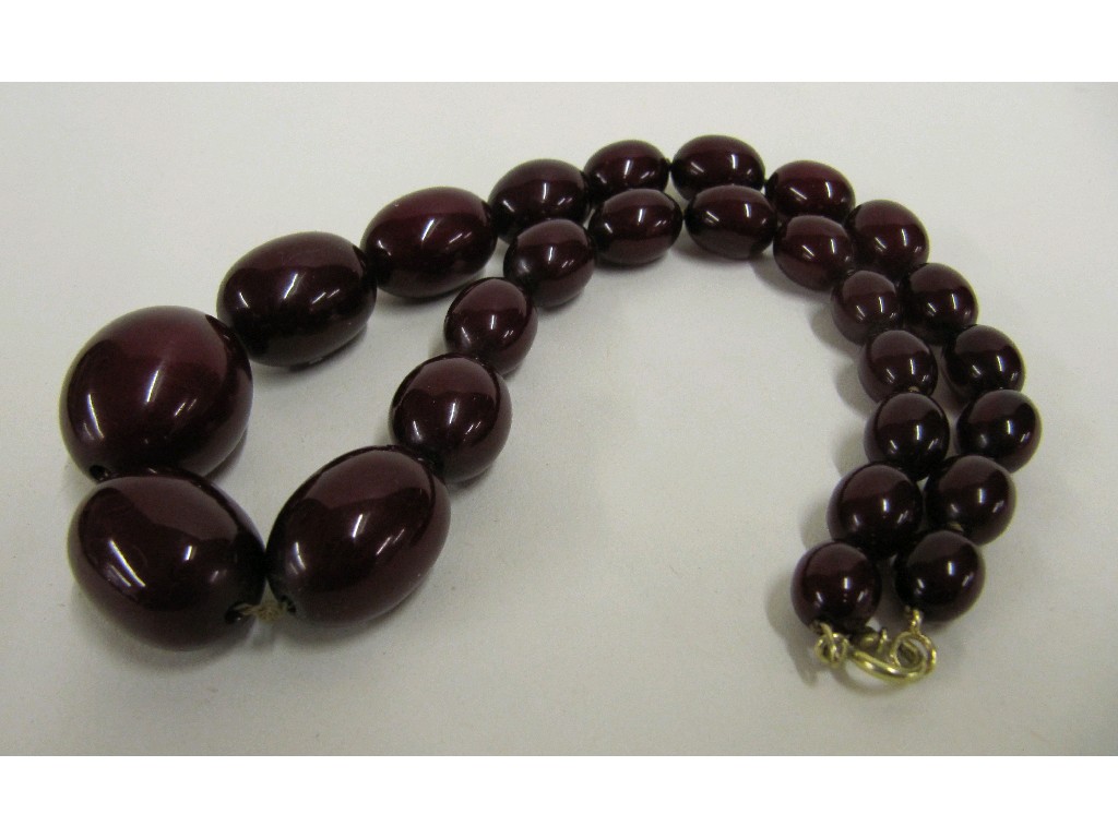 Appraisal: String of red amber beads Approx in