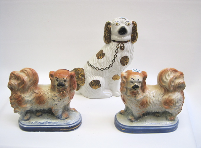 Appraisal: GROUP OF THREE ENGLISH STAFFORDSHIRE SPANIELS One has copper lustre