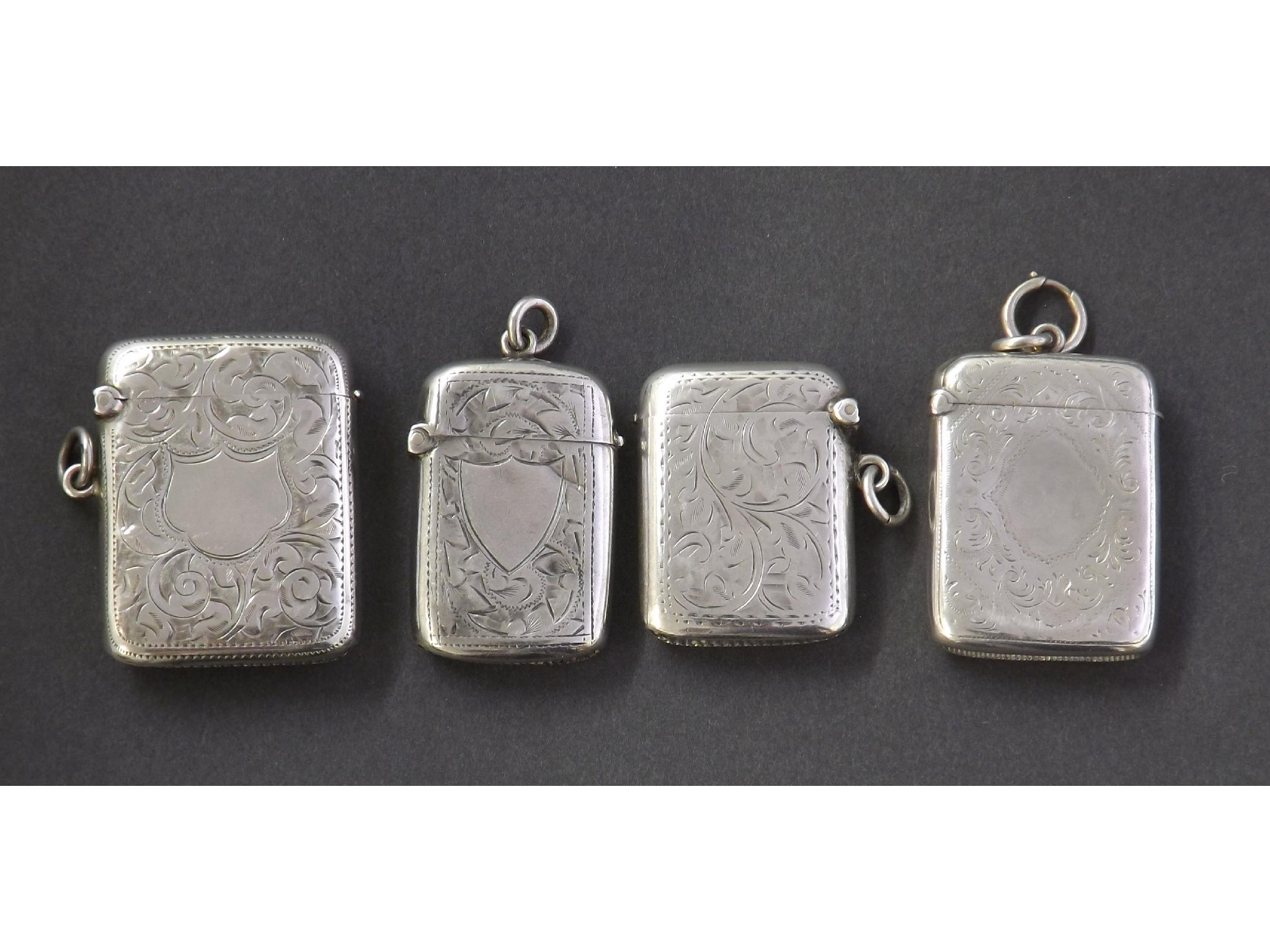 Appraisal: Four silver vesta cases each with engraved floral decoration oz