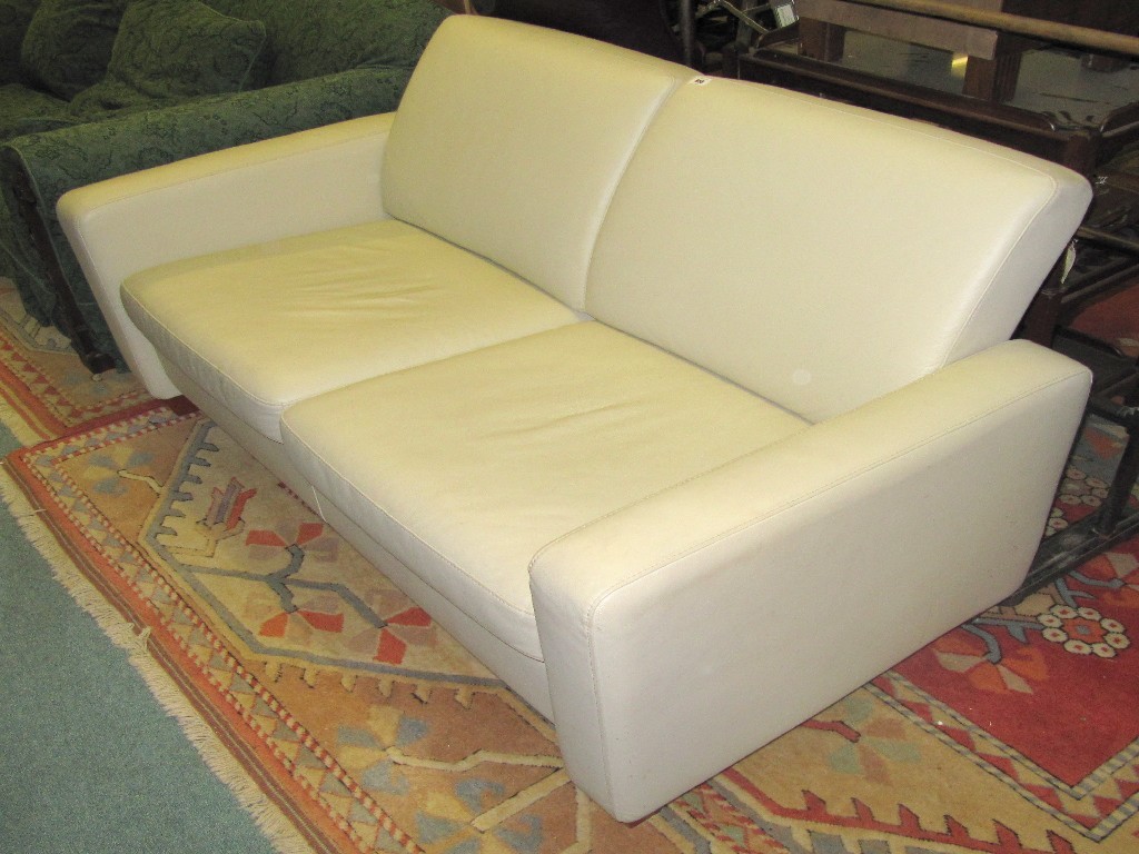 Appraisal: Cream leather upholstered two seater settee