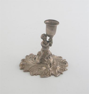 Appraisal: A Victorian taperstick modelled as a putto holding aloft a