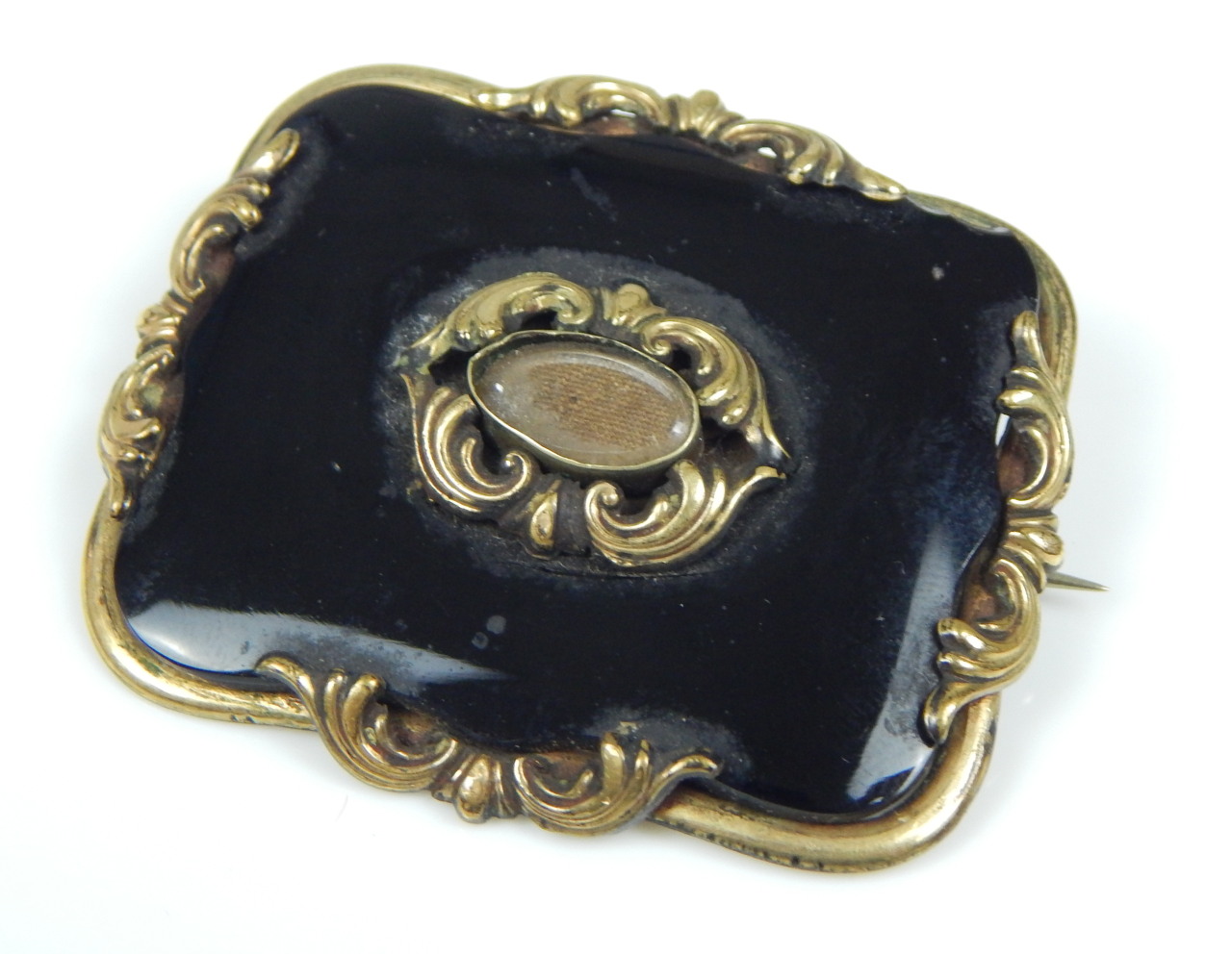 Appraisal: A Victorian memorial brooch with black polished stone in gilt