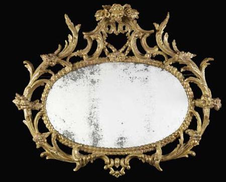 Appraisal: A George III carved giltwood oval wall mirror circa the