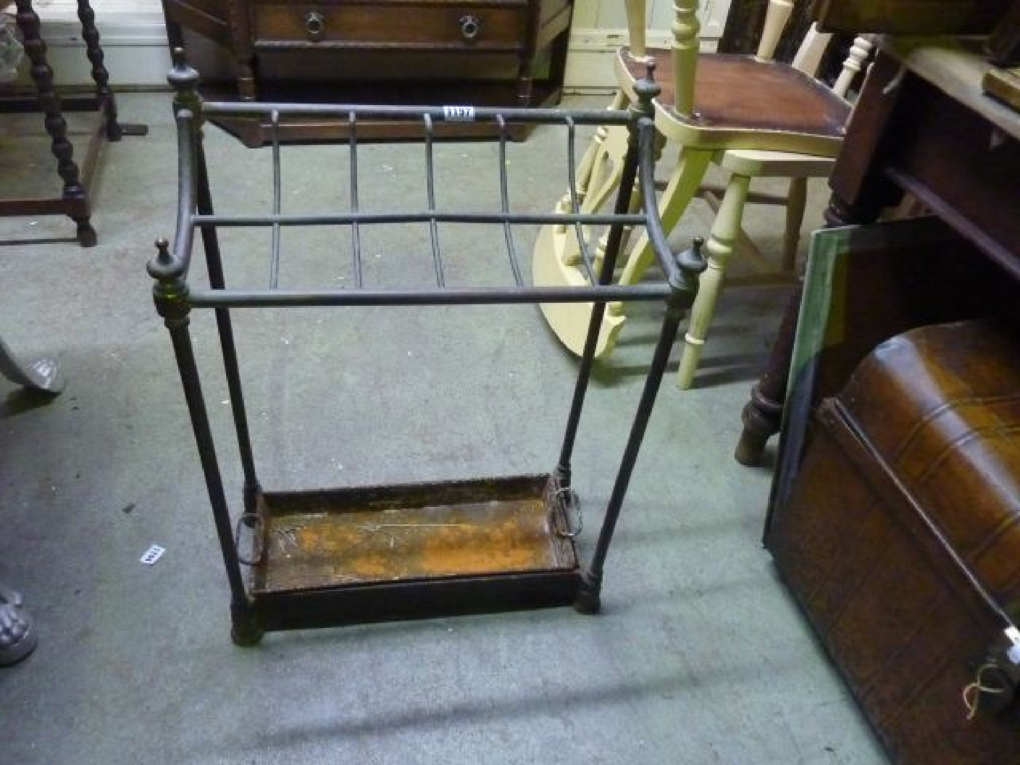 Appraisal: A Victorian brass and iron stick stand with twelve divisions