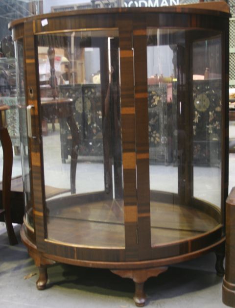 Appraisal: A mahogany veneered display cabinet with glass shelves