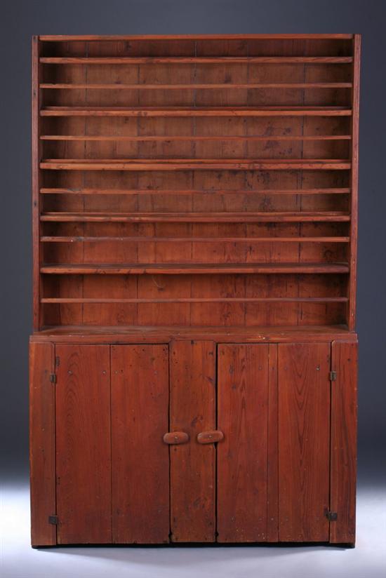 Appraisal: AMERICAN PRIMITIVE PINE STEPPED-BACK PLATE CUPBOARD th century with restorations