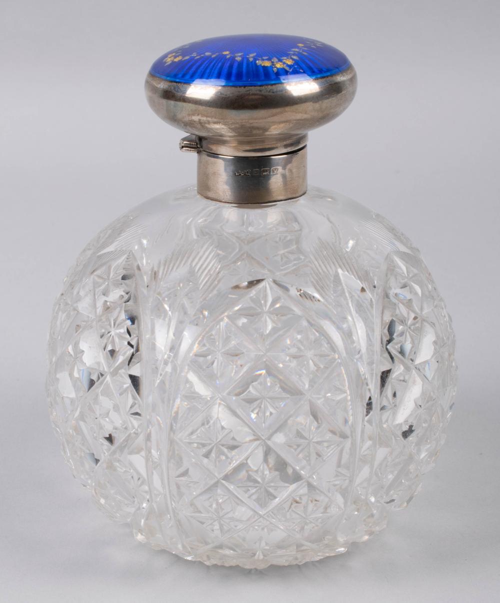 Appraisal: CUT CRYSTAL PERFUME BOTTLE WITH SILVER AND GUILLOCHE ENAMEL TOP