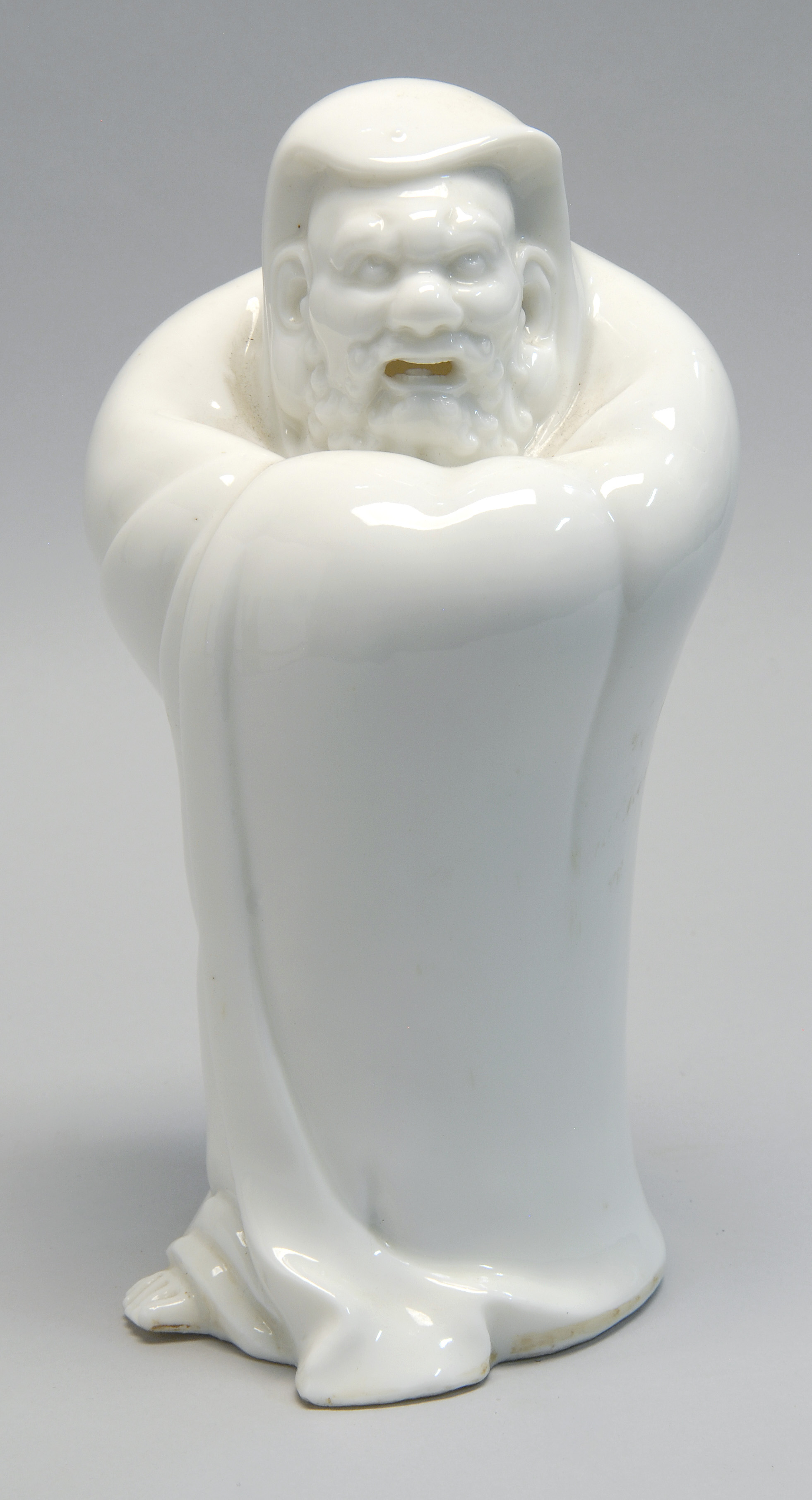 Appraisal: STUDIO PORCELAIN FIGURE OF DARUMA Early th CenturyIn white glaze