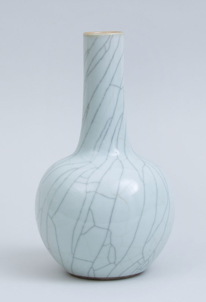 Appraisal: CHINESE IVORY CRACKLE-GLAZED PORCELAIN BOTTLE VASE With sticker from the