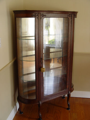 Appraisal: LATE VICTORIAN BOW SIDE OAK CHINA CABINET Glass shelf and