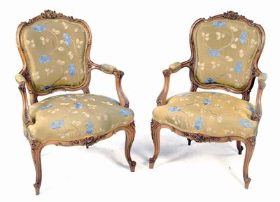 Appraisal: A pair of Louis XV style carved walnut fauteuil upholstered