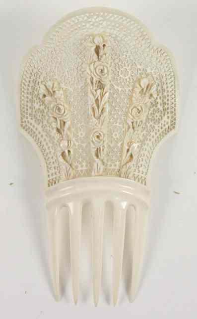 Appraisal: A late th Century carved ivory hair comb of shaped