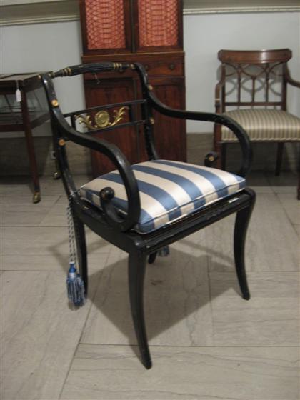 Appraisal: Regency black painted and brass mounted armchair The backsplat centered