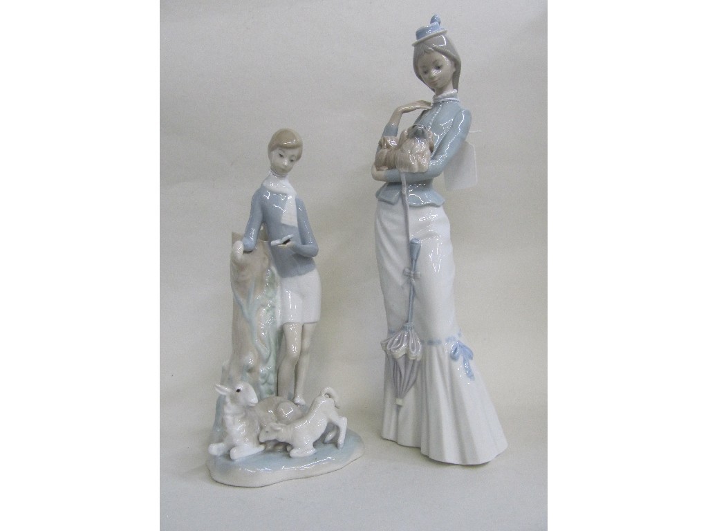 Appraisal: Two Lladro figures of a woman carrying a dog and