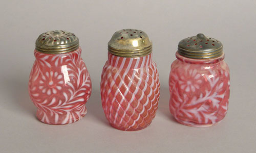 Appraisal: Three cranberry and opalescent glass shakers ca h two -