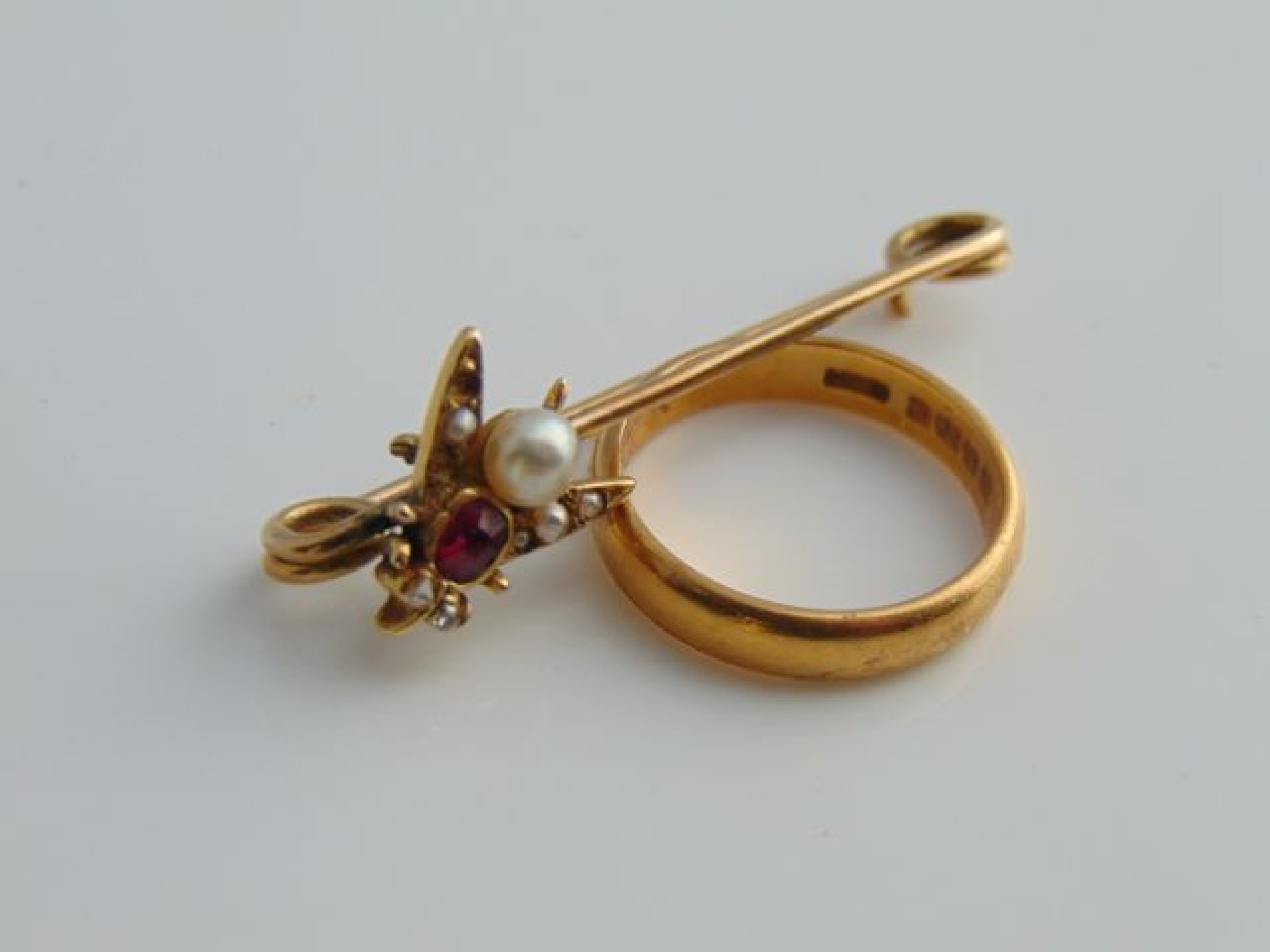 Appraisal: A Victorian safety pin brooch highlighted with a gem-set insect