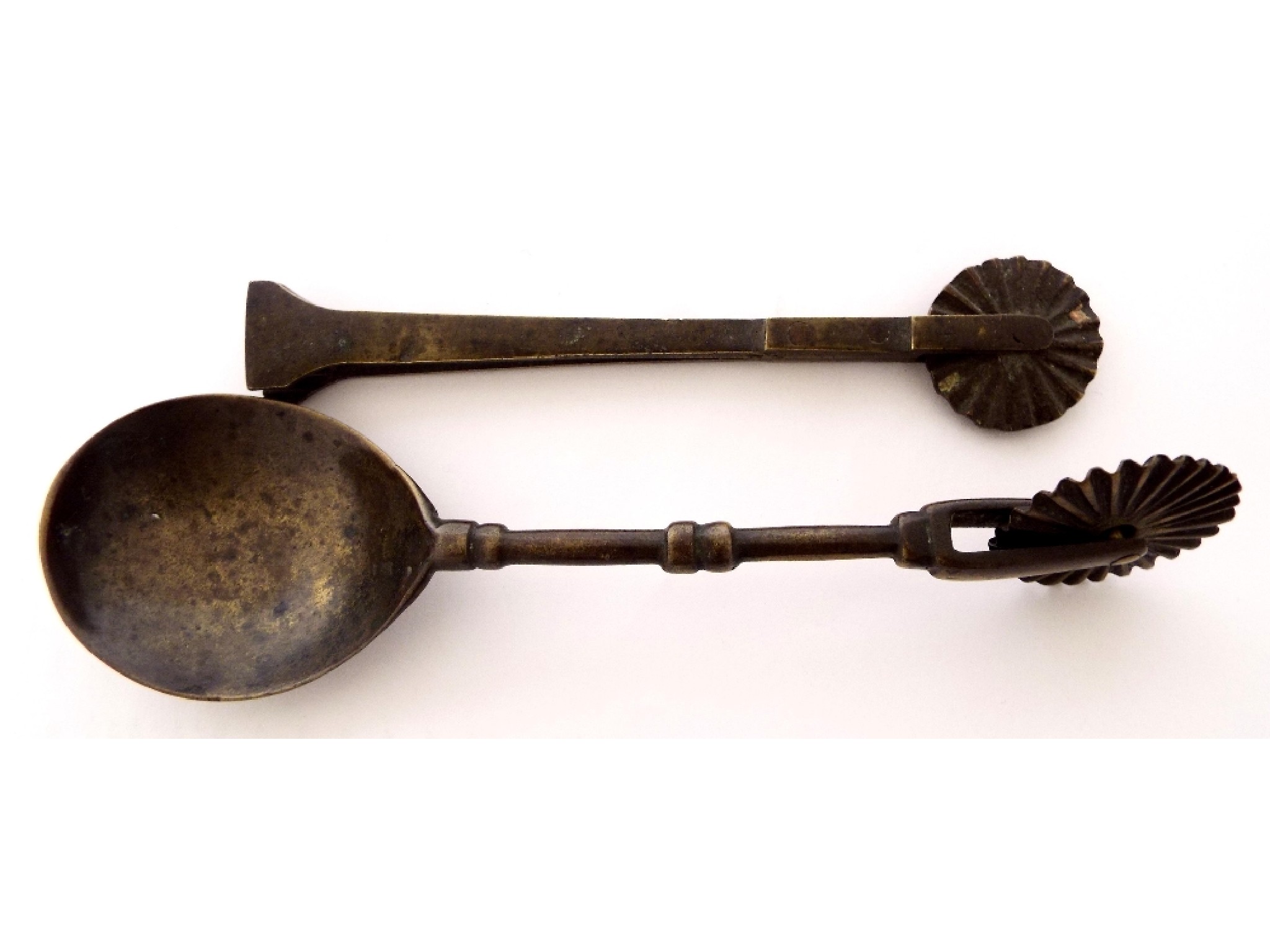 Appraisal: th century latten spoon with pastry wheel and a further