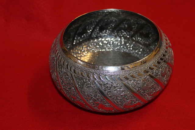 Appraisal: A CEYLONESE WHITE METAL BOWL of circular form with profuse