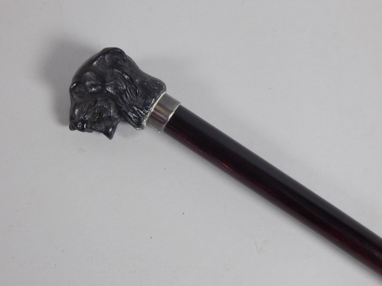 Appraisal: A thC ebonised walking stick the composition handle cast in