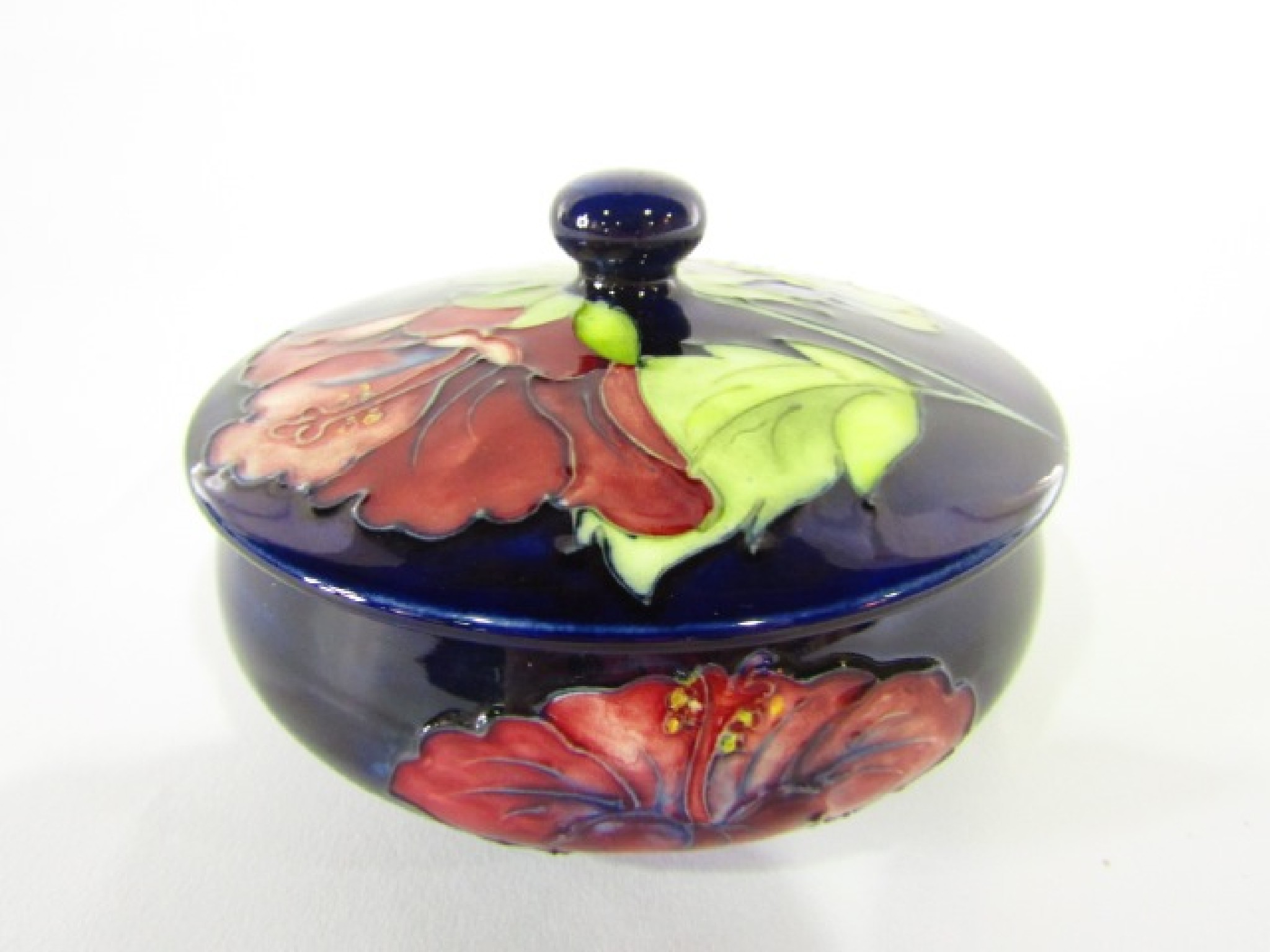 Appraisal: A Moorcroft dark blue ground powder bowl and cover with