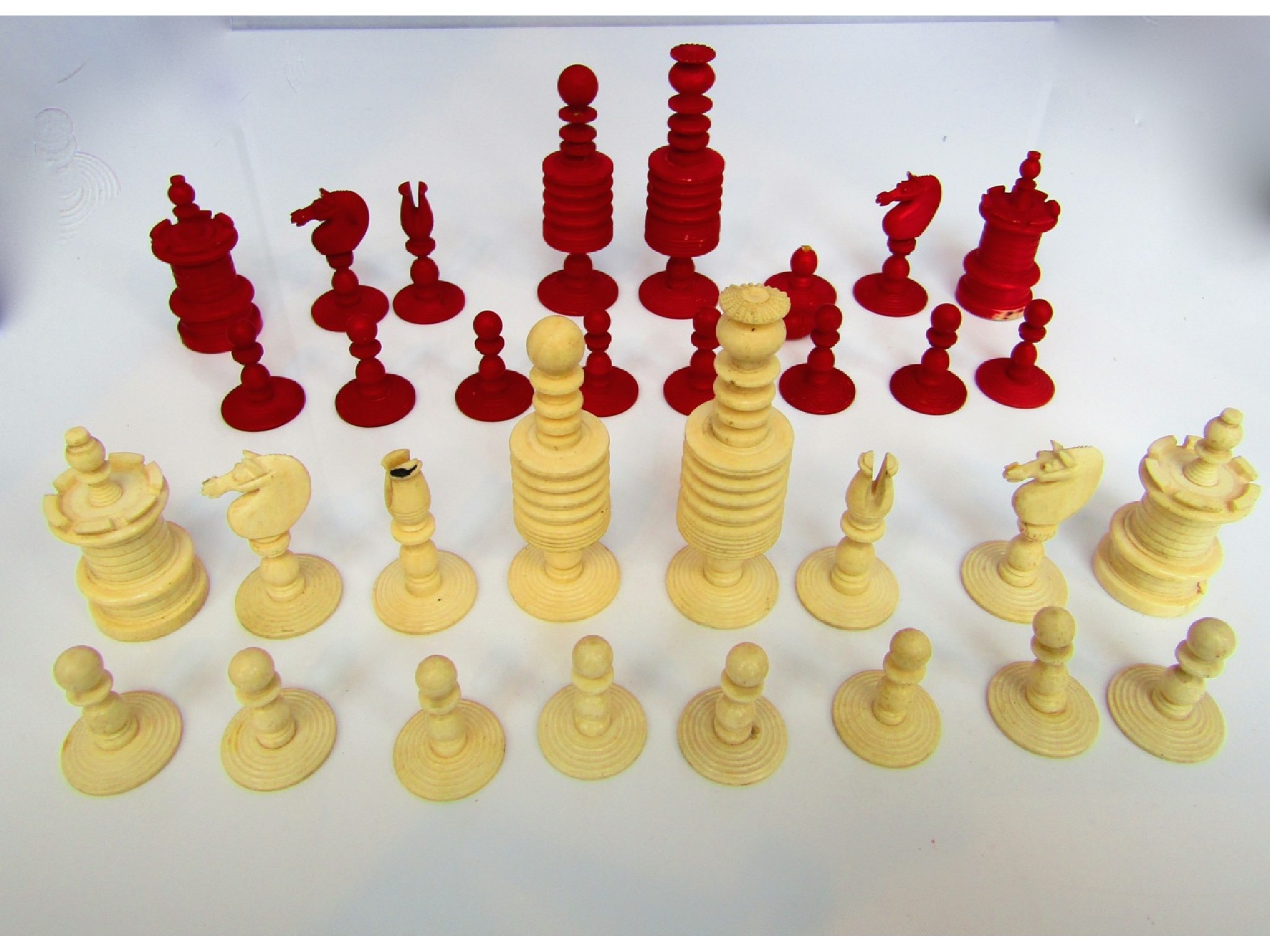 Appraisal: A complete th century turned ivory chess set with well