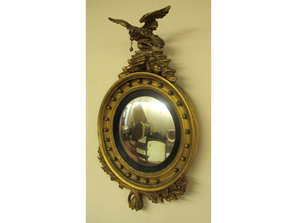 Appraisal: A Regency gilt wood convex wall mirror with carved eagle