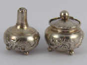 Appraisal: A Chinese silver pepper and mustard on three ball feet