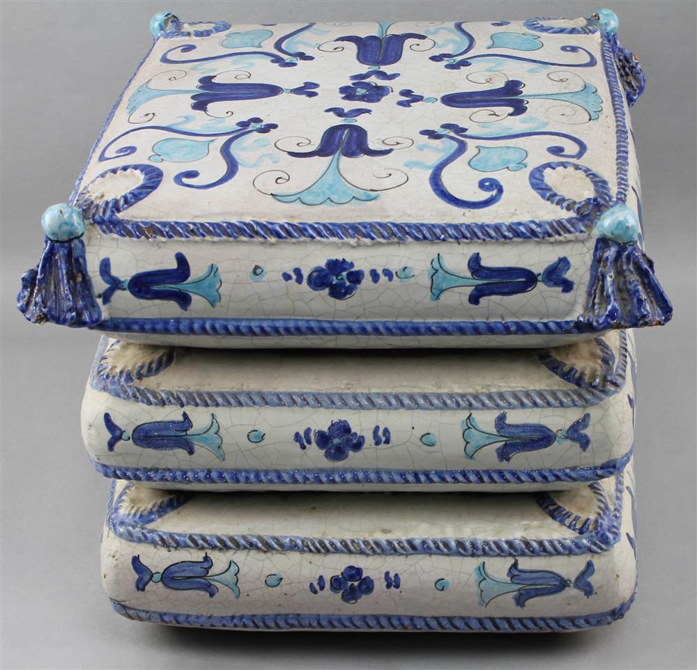 Appraisal: CERAMIC OTTOMAN WITH BLUE GLAZED DESIGN AND TASSELS with triple-pillow