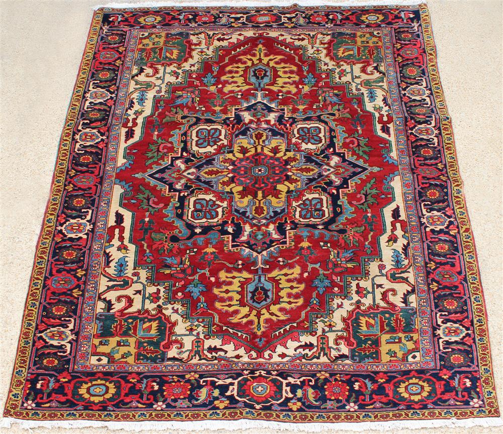 Appraisal: PERSIAN HERIZ WOOL RUG approx years old colors include reds