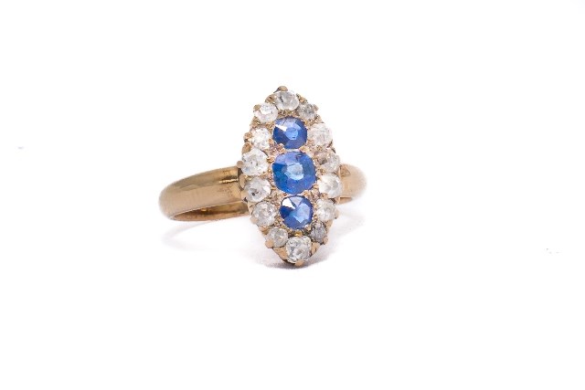 Appraisal: A gold sapphire and diamond set marquise shaped cluster ring