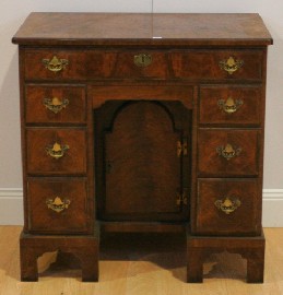 Appraisal: A Queen Anne style walnut cross banded knee hole desk