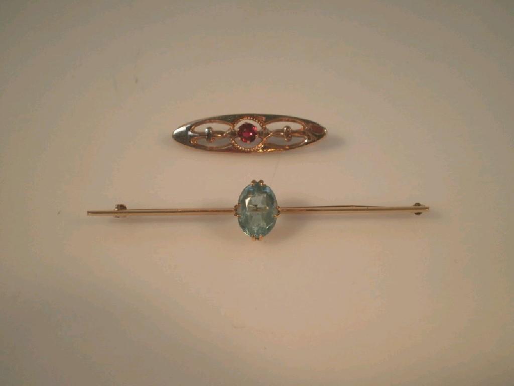 Appraisal: A bar brooch set with a pale blue stone possibly