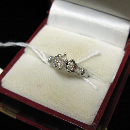 Appraisal: DIAMOND AND PLATINUM RING set with three marquise-cut diamonds and