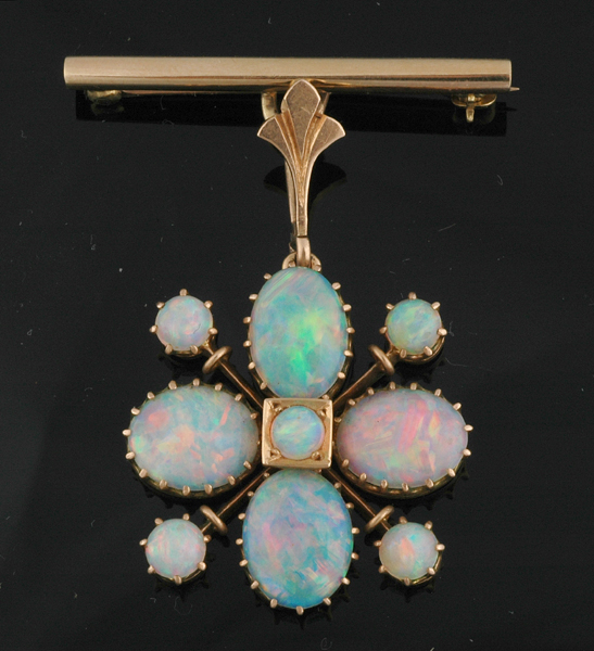 Appraisal: AN OPAL FLOWER PENDANT BROOCH Set with eight alternating oval