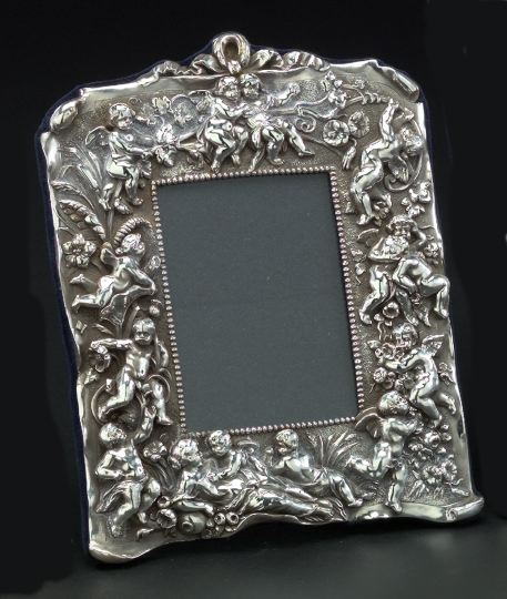 Appraisal: English Embossed Sterling Silver-Faced Photograph Frame in Putti and Flowering