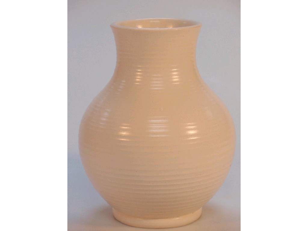 Appraisal: A cream ribbed baluster vase incised signature of W Moorcroft