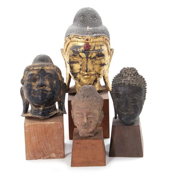 Appraisal: Asian Buddha heads on pedestals probably Chinese th century or